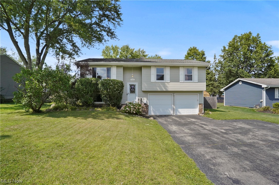 Welcome home to this move-in ready, gorgeous three bedroom, two bathroom bi-level with a unique and versatile floor plan to fit all your needs. The main level offers a carpeted living room with a large south-facing window to let abundant natural light shine through. The living room is open to the dinette, which has slider doors to a huge, covered deck with two ceiling fans and plenty of space to sit out and enjoy the view of the large fenced in backyard. The fabulous, bright, open kitchen has an abundance of cabinets, double sink, stove, built-in microwave, dishwasher, and refrigerator. To finish the main level there is a full bathroom and three bedrooms, two carpeted and one with laminate flooring. The lower level offers more space for a family room, office, or a fourth bedroom. The lower level includes a full bathroom, as well. There is extra storage space under the covered deck. Two car garage with large built-in cabinets and shelves for storage, two garage door openers, and large d