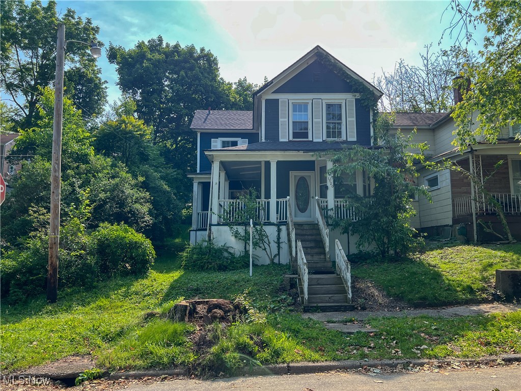 The first floor consists of a living room with a bay window, a Kitchen with an island, a dining area, and a bathroom. The second floor offers three bedrooms and one full bathroom. The home has a large wrap-around style front porch. Nice backyard with glass sliding door to dining area and man door to kitchen.