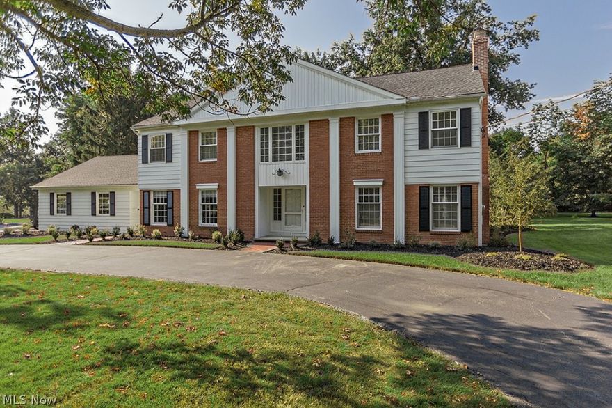 Stately Georgian colonial boasts a dramatic foyer w/marble floors and sweeping staircase. Great flow between formal living room w/fireplace, spacious dining room, updated kitchen w/granite counters, cherry cabinets and newer appliances adjacent to warm family room with fireplace, wet bar and beamed ceiling. Private library appointed with many built-ins, utility/mud room and full bath complete the first floor.  Wonderful 2nd floor has 4 large bedrooms, all with newly finished hardwood floors and walk-in closets. Unusual master suite has sitting room, vanity/dressing room, two walk-in closets and private bath. Guest bath has two sections for multi-tasking. Tons of storage available in 2 large linen closets and additional space in attic, neutral décor throughout.  Finished lower level room has fireplace and plenty of space for play and recreation. Convenient circular driveway, 3 car garage, patio with awning overlooks park-like, private, wooded backyard.  Great Orange schools and communit