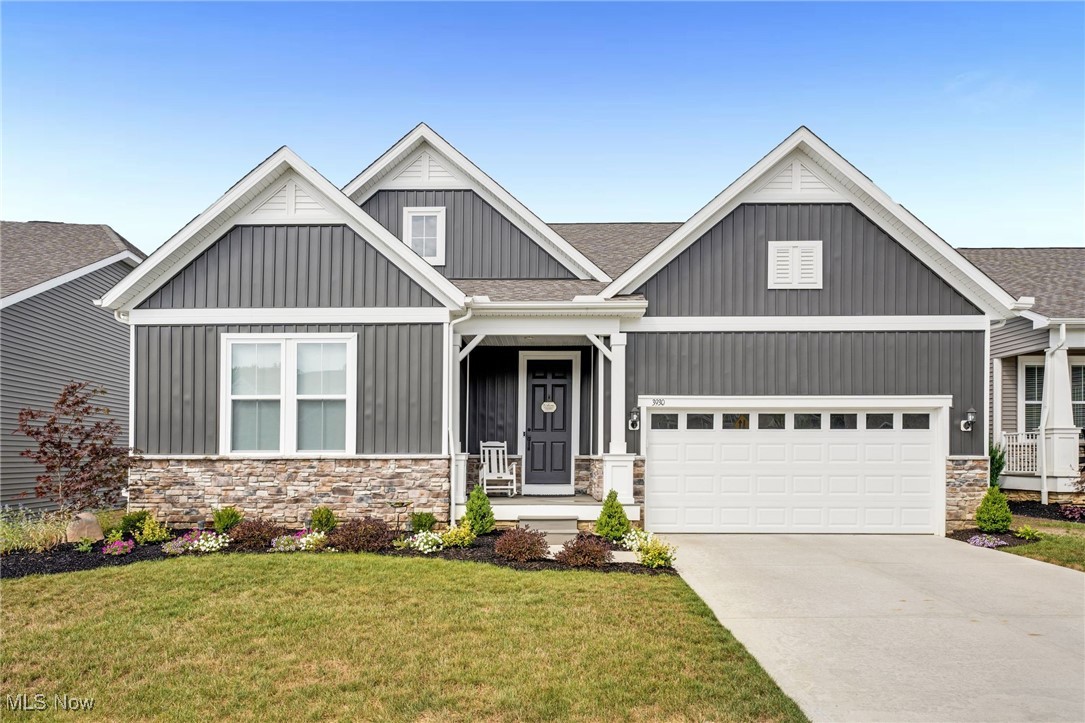 Discover modern living in this beautifully upgraded residence situated in the highly desirable Brier Creek community! With its captivating Country View floor plan, this home features 3 spacious bedrooms and 2 luxurious bathrooms. The exterior impresses with contemporary vinyl vertical board and batten siding, white trim accents, and decorative gables. A welcoming entryway leads you to a front porch with durable composite decking. Enjoy panoramic views from the covered patio, enhanced with solar screens. An additional concrete patio invites you to soak in the serene surroundings. Step inside to a great room that boasts high ceilings and a cozy fireplace. The neutral color palette creates a warm atmosphere, ideal for both entertaining and relaxation. The kitchen features upgraded cabinetry with decorative trim, striking porcelain backsplash, and granite countertops. With upgraded appliances, including a double oven, expansive walk-in pantry, and a spacious center island with ample storage, this kitchen impresses. Retreat to the master suite, where natural light and a tray ceiling create an airy ambiance. The master bathroom offers a double vanity, stone countertop, and a stunning walk-in shower with custom bench seat and floor-to-ceiling glass walls. The main-level laundry room includes thoughtful storage solutions, utility tub, and backsplash. Finally, the basement presents endless possibilities, ready for your creative vision—transform it into a home gym, rec room, or functional storage space. Recent updates include: kitchen tile backsplash, upgraded light fixtures, new concrete patio, new landscaping, upgraded appliances, granite counters, new blinds, upgraded carpet, new phantom screens, ERV air exchanger, radon mitigation machine, back up battery sump, outdoor solar screen, and sprayed ceilings in the basement. This home, with its low-maintenance living and proximity to shopping, parks, and recreation, is a luxurious retreat waiting for you to call it your own!