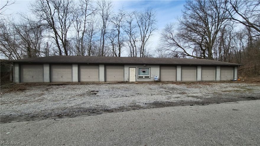 Currently, beings used as office space with 7 storage bays. Bay 5 is actually office space also and it can be converted back into a garage bay. All garage bays have electricity, and bays 4 and 7 have garage door openers. There is a full bathroom, baseboard heat, hot water tank, and a nice enclosed deck off the back of bay 5.