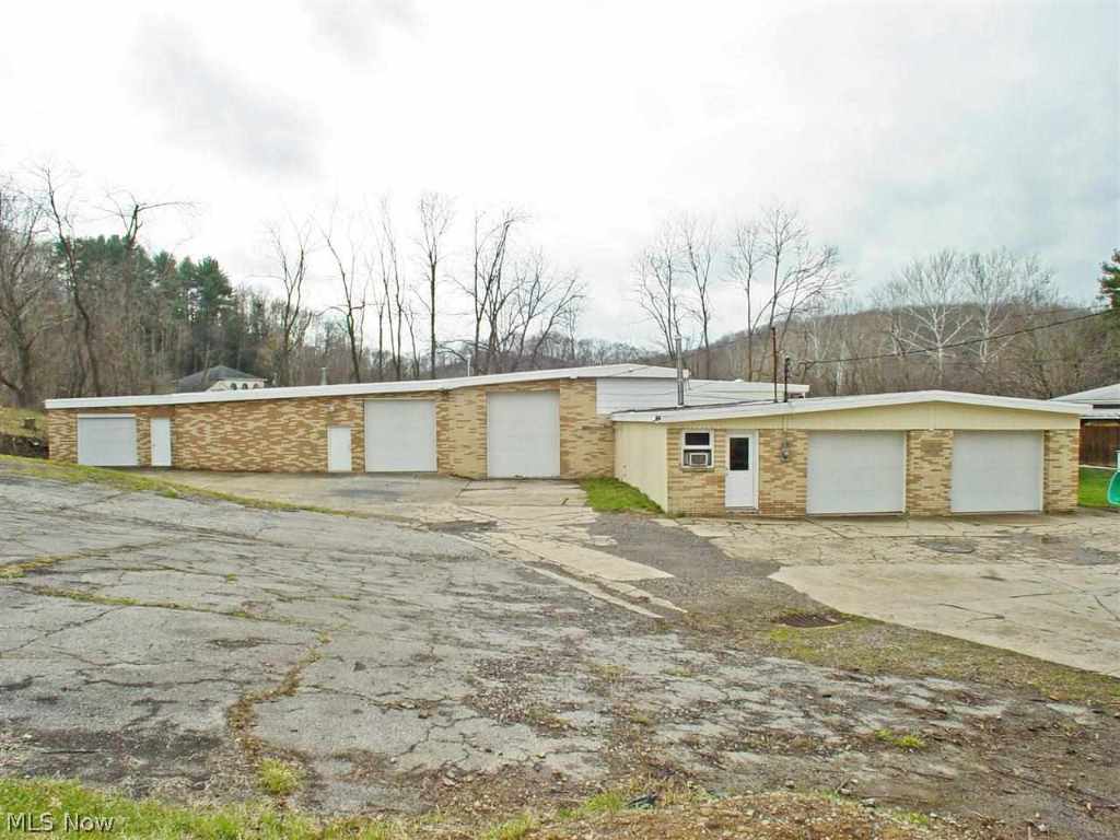 Rare find - Great opportunity in business and/or warehouse space. Approx. 9,000 sq ft of brick front block bldg. w/ overhead garage doors. Ample parking for approx. 30 cars/truck. Office, supply room, storage area and restroom. 3 BR home included in sale. All on 1.3 acres.