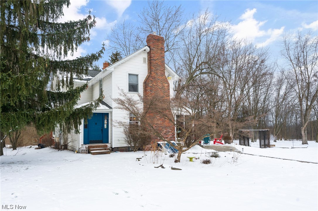 Canfield Modern Farmhouse with character and charm; This adorable home is located in Canfield Township and Canfield LSD, just minutes from all of the amenities and the feel of living in the country. This home mixes new and old, the kitchen has old post and beams combined with SS appliances and granite counters, ceramic wood plank flooring, built-in shelves and an appliance garage. Around the corner is the living room with brick fireplace, there is a den off of the living room, currently a home office and the large dining room with window seat and french doors to the deck. The first floor has exposed joists that are rough sawn and refinished wood floors. Second floor consists of two huge bedrooms, a large walk in closet and updated full bath with jetted tub and feature wall. There is an enclosed porch on the back that currently serves as a mudroom and a large patio added in 2023. Large garage and a carport, chicken coop and private backyard. Don't miss this one.