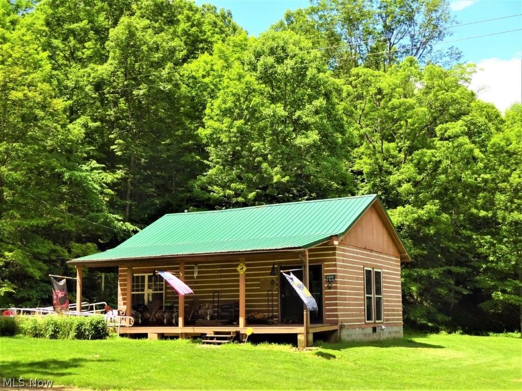 40+ acres surveyed. Beautiful private log home. Master loft bedroom overlooks great room, wood burning stove. Built in kitchen, breakfast bar, one full bath, forced air heat, dining room , sliders to rear deck, covered front porch, large level lawn, offers blueberry bushes, pecan, black walnut, peach and paw paw tree! BBQ area grill, oversized 33x24 garage, concrete floor, work benches, stairs to unfinished floored loft (ready to finish for man cave or storage) 14x20 shed. Enjoy the sounds of babbling brook. Area for livestock. Level area for another home. Generac whole house generator. Special needs removable ramp. All owner mineral rights convey. Excellent hunting, perfect county location for your private home or retreat. Many extras. Beautiful peaceful location. A must see!