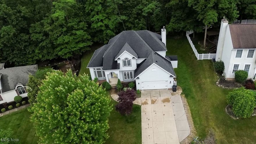 Beautiful, custom-built, 4-bedroom Colonial nestled within lovely wooded lot in quiet, walkable neighborhood. Meticulously maintained new shades in Family Room(2023) Replaced chimney cap(2023) carpeting living/dinning room(2021) New luxury Vinyl flooring(2020)New Granite Kitchen countertop(2015) New Shed(2017) and many more . Open concept floor plan offers relaxed flow for entertaining and everyday living. Abundant natural light bathes interior, making entire home bright and inviting. Warm, welcoming kitchen, with gleaming hardwood floors and granite countertops, has sliders leading to backyard deck for easy outdoor living. Enjoy family room’s cozy, raised hearth, gas/wood-burning fireplace in the months to come! Generous storage on every level. Convenient, first-floor laundry. Heated lower level, with over 1000 sq ft of partially finished space, is pre-plumbed for fourth bath. Heated garage has hot and cold spigots, workbench, and cabinets for organized storage. See supplements for more info and updates. This property has Akron taxes and utilities, but is located within Woodridge Local School District and has Cuyahoga Falls mailing address. Ideal, central location feels tucked away yet easily accessible to city facilities and interstate system. Plus, just minutes from hiking/biking trails of Cuyahoga Valley National Park and Summit Metro Parks, Boston Mills and Brandywine Ski Areas, Stan Hywet Hall and Gardens, the wonderful shopping, dining and entertainment of Cuyahoga Falls - including Blossom Music Center and Sarah’s Vineyard - and more. Schedule your private showing today!