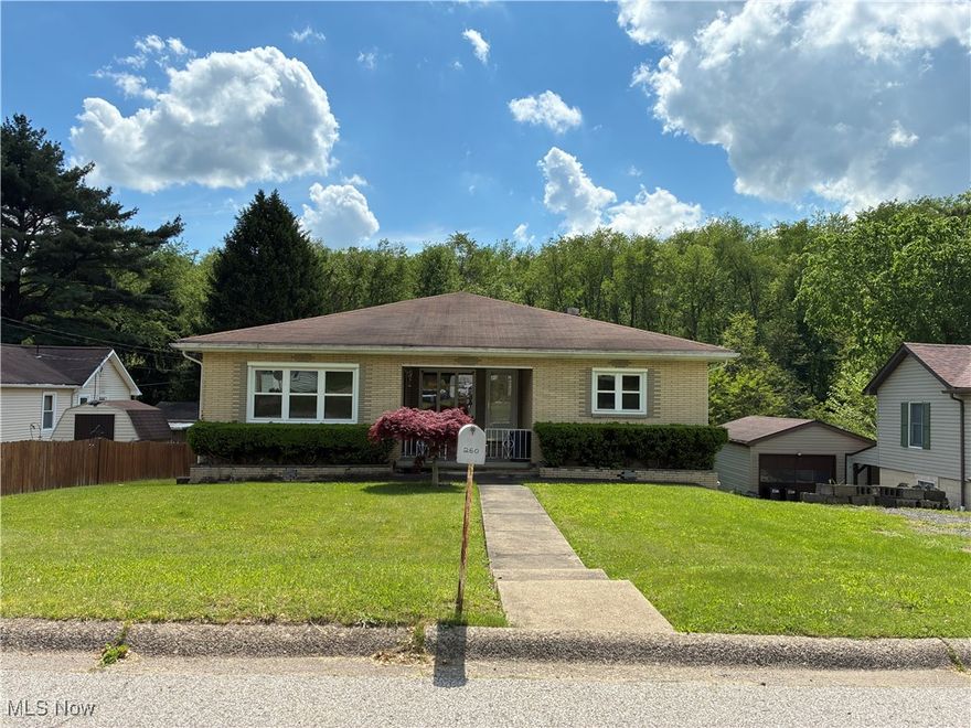 Welcome to this charming and spacious 3-bedroom, 3-bath brick ranch, ideally located just minutes from local hospitals, Robinson/downtown Pittsburgh, Route 22, shopping, dining, the airport, and more. This well-maintained home features brand-new wood grain laminate flooring and fresh paint throughout. Upon entry, you'll be greeted by a bright and inviting living room that flows into an eat-in kitchen with ample space and direct access to a covered back porch—perfect for relaxing while enjoying views of serene woods and added privacy.  Step down into a versatile dining room or main-level family room, offering plenty of space for entertaining. The primary bedroom includes a convenient half bath.  The fully finished lower level offers excellent flexibility, featuring a second large kitchen with whitewashed cabinets, granite countertops, a glass tile backsplash, and new laminate flooring. A remodeled full bath and a spacious rec room open to a backyard patio—ideal for outdoor gatherings. This level is perfect for a mother-in-law suite or potential rental income.  Additional highlights include multiple storage rooms, a workshop, and a laundry area. With replacement windows, fresh paint, and new flooring throughout, this immaculate home is truly move-in ready—offering both comfort and convenience.  Don’t miss your chance to make this lovely home yours—schedule a showing today!