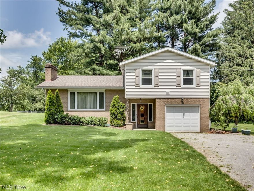 What an opportunity!  Move in and enjoy or update to your own preference.  This spacious split level offers a formal living room that features a vaulted ceiling and wood burning fireplace, an eat in kitchen that includes all appliances (fridge and stove are stainless steel), and a dining room with a slider to the patio. Natural sunlight from the huge picture window accentuates the gleaming hard wood flooring. There are 3 large bedrooms and a bathroom with double sinks on the second level.  The 4th bedroom is located on the main level and could also be used as  extra living area.  The partially finished basement features a wood burning fireplace.  Updates in 2007 include roof, windows, septic and vinyl siding.  The hot water tank was recently installed.  The 100x300 yard is partially fenced and gives you plenty of room for outdoor activities. Don't miss the chance to preview this great home.  Call for your private showing today.