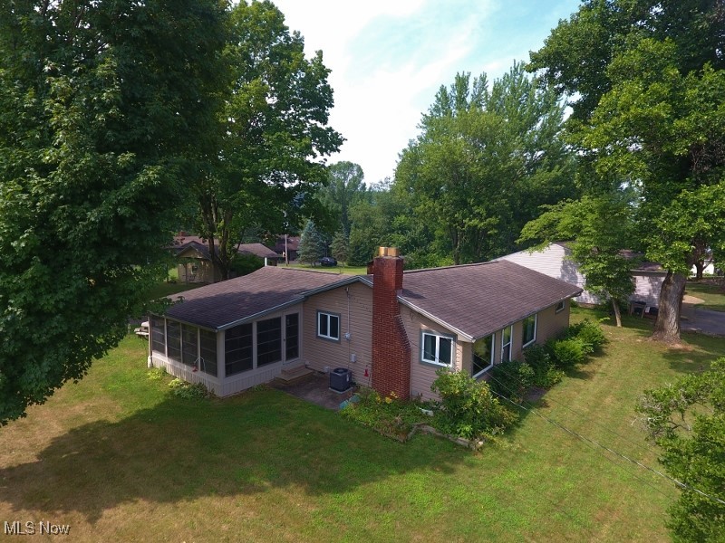 Welcome to this well-maintained 2-bedroom, 1.5-bath ranch home in the sought-after Atwood Valley community at Atwood Lake. Whether you're looking for a year-round residence or a weekend escape, this turnkey property is a perfect fit. Enjoy limited lake views year-round, with expanded views during the fall, winter, and spring. A dock slip through the Atwood Valley Docking Association is included, offering direct access to 1,540 acres and 28 miles of scenic shoreline on beautiful Atwood Lake. Set on two spacious, privately owned lots totaling 0.55 acres (no lease fees), the property features mature hardwood trees and plenty of space for outdoor living, gardening, or pets. This fully furnished home is move-in ready, with immediate occupancy available—just in time to enjoy the rest of the 2025 lake season. The updated kitchen offers Birch cabinetry, new vinyl plank flooring, and all appliances included. The cozy living room features a gas fireplace, ideal for cooler evenings. A bonus room, currently used as additional living space, can easily be converted into a third bedroom to suit your needs. One of the standout features is the large three-season enclosed porch, the perfect spot to unwind and take in the surroundings. The full bath includes a newly installed oversized shower, and there's also a convenient half bath. Outdoor enjoyment continues with a 10x14 deck ideal for entertaining. Additional updates include a new central A/C system installed in 2024 and newer Andersen windows throughout. A 24x22 garage provides one-car parking and ample storage for tools, lawn equipment, or lake gear. The home is also wired for a backup generator, offering added peace of mind. Don’t miss your chance to own this charming lake home and start making memories. Schedule your private showing today & be sure to check out the 3D virtual tour. Please note: mineral rights will be retained by the sellers. A John Deere riding mower & portable generator are available for purchase separately.