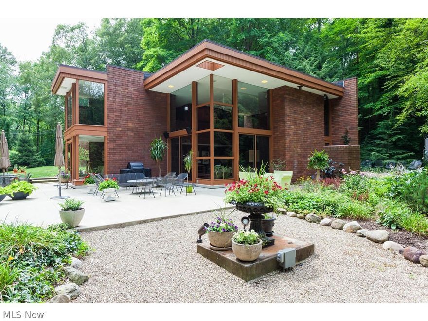 Exceptional mid-century home on beautiful Yellow Creek in Bath! Conveniently located within a short distance from Cleveland and within minutes from west Akron. Walls of REDWOOD, BRICK, and GLASS– Gorgeous views from every room! An expansive pathway leads you to the private entrance of this fabulous architecturally designed showpiece. From the moment you enter, you feel absolute tranquility. The foyer leads into a stunning two story Great Room with large wood burning fireplace and soaring 16’ floor to ceiling windows! Kitchen has loads of storage, center-island, Viking range, and Dacor double ovens. Every room overlooks the woods and creek, providing an absolute fantastic and secluded retreat. Two Bedrooms and a large full bath are located on the first floor. A spacious loft style Master Suite boasts hardwood floors and separate living area with floor to ceiling windows. A large two car, attached garage greets you at the end of the hallway that is lined with roomy closets for more than