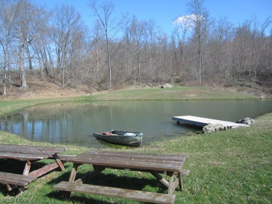 43 acres, about 1/3 wooded, remainder open fenced pasture and fenced hay fields. Hay/cattle shed and large pole barn, good springs, large stocked pond. Excellent building sites on this property just 2 mile from Walmart on CR 10. Currently used as cattle pasture and hay fields with deer hunting haven in the woods with deer shack and food plots.  Top quality acreage to build on, with beautiful valley views. Rent pasture and hay fields for income, hunt your own land, build when you are ready.  Mineral rights transfer, not under lease per owner.