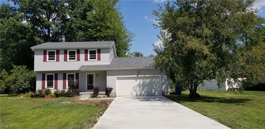 Four bedroom Colonial Home in Mineral Ridge with brand new roof-2017, & vinyl siding, gutters, new front porch and concrete driveway!!  Updated electric, updated kitchen in 2015 with Maple cabinetry, granite counter tops, slate background, undermount sink, newer flooring, stainless steel gas stove with  range hood.  First floor bedroom with french doors to patio.  Huge yard!  Check out this amazing home with all of the updates, HWT 2013, new sump pump.