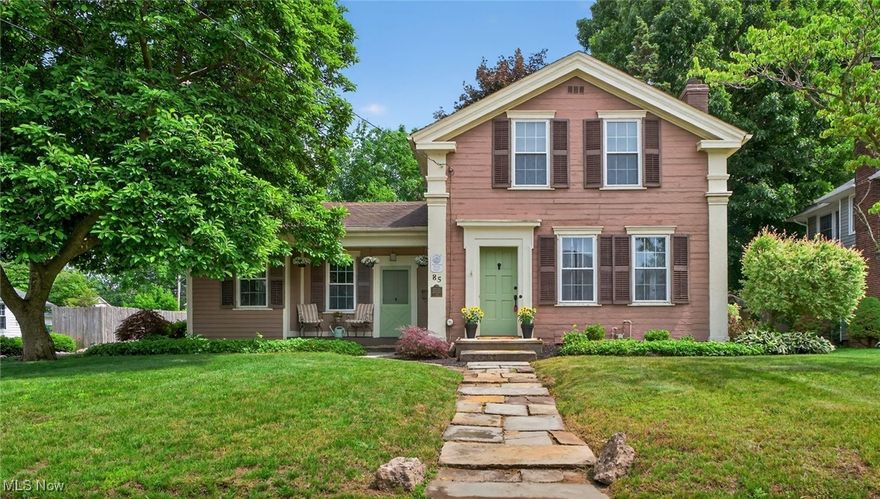 Do you appreciate the unmistakable character and solid quality of a historic century home? Located in the prestigious Mentor Avenue National Historic District of downtown Painesville, this updated, well cared for home was built by Lake County known architect Jonathan Goldsmith and sits on nearly half an acre.  Literally travel down a brick road to this lovely 2 bedroom, two bath room home, featuring a first floor study with solid wood built-ins that could be repurposed as a first floor bedroom if desired.  Do you enjoy entertaining? This large home's main floor offers a spacious living room with wood burning fireplace, an adjacent pretty sunroom to relax in while overlooking the private backyard.  The well designed, eat-in kitchen boasts stainless appliances, a farmhouse sink, a walk in butlers pantry, and is adjacent to the formal dining room that exits onto your cozy covered front porch.  A first floor powder room is convenient for guests and you will love the oversized laundry/mudroom conveniently located to the rear of the home on the main floor.  Boasting lots of natural light, plenty of built in storage and a convenient rear exit, no more traveling down to the basement to do your laundry.  Head upstairs to a large primary bedroom with cedar lined closet, and a second ample bedroom.  Your updated full bath features a jetted, soaking tub, a ceramic tile lined shower and full vanity.  The wide plank hardwood floors throughout lend an air of gracefully aged character not found in modern construction today.  Downstairs, the full, bright basement has a walkup exit to the rear yard and plenty of room for year round storage.  This home has had many updates over the years and was just freshly painted throughout.  Seller is also offering a full one year home warranty for your peace of mind. Did we mention you can walk to the festivals and events on the city square? Just bring your belongings and move in to this beautiful piece of Ohio history.  Call to tour today.