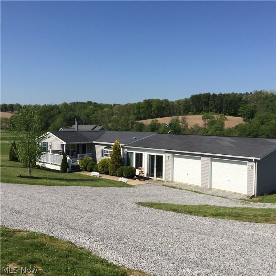 This beautiful setting surrounds our 3 bedroom/2 bath home with cathedral ceiling plus stunning fireplace.  Great view from all windows, as well as lovely 10x18 front porch, and 16x28 insulated breeze way heated by gas stove  All carpet is less than 2 years and kitchen and bath remodeled about 2 yrs ago.  New pressure tank in well and hot tub reconditioned.  Plus 20x24 pole building with side deck.   Move in condition, you will love it!