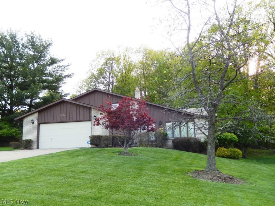 Wonderful split level offering nearly 2,300 sf of living space! Living and dining rooms feature volume ceilings and neutral carpet. All appliances remain in kitchen which is just a step up from the beamed family room with woodburning fireplace and covered patio acccess. 4th bedroom or den, 1/2 bath and laundry room complete the 1st level. On second level you will find 3 additional generously sized bedrooms and two full baths, one being private master bath. Lower level rec room finished for additional living space. Serene wooded view from back yard covered patio. Lots to offer!