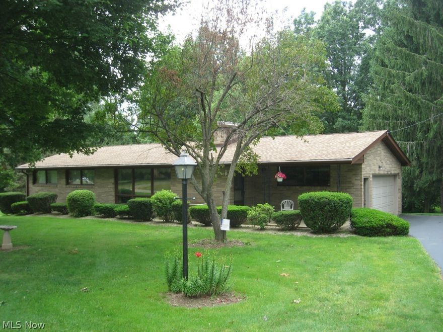 All brick ranch home that is in move-in ready condition.  The friendly floor plan provides a spacious living room with fireplace, kitchen with wood cabinets, cupboards and full complement of appliances, ample sized dining room, sun room with slider door access to the deck and excellent view of the tree-line back yard, master bedroom with pristine hardwood flooring,  2 additional bedrooms of good proportion with ample closet space, a finished walk-out basement with recreation room with day light windows and sundae bar, laundry room with washer and dryer, an oversized 2 car attached garage, a well maintained and spacious deck; all situated on a very nice lot with mature trees and landscaping.  The home is enhanced by a high-efficiency furnace, updated roof shingles, updated hot water tank, central air conditioning, 100 amp electrical service on breakers, whole house fan and a waterproofed basement.