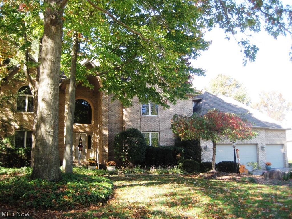 Regal, brick front colonial, nestled in desirable Heritage Woods, features open floor plan with gleaming hardwood floors & exceptional craftsmanship. Welcoming covered entry leads to gracious, two story foyer w/open, curved staircase & hardwood flooring. Foyer opens to inviting, formal living room w/crown molding. Elegant, formal dining room boasts glass pocket doors, crown molding, & large window overlooking backyard. Spacious gourmet kitchen offers center island, breakfast bar, extensive cabinetry, stainless steel appliances incl. double ovens, planning station, track lighting, hardwood flooring, & separate eating area w/access to deck. Kitchen overlooks family room. Engaging family room presents floor to ceiling, brick fireplace, flanked by built-ins, & glass pocket doors to sun room. Bright sun room showcases bar area, cathedral ceilings, panoramic views of tranquil backyard, & sliders to deck. Glass French doors lead to handsome, first floor office w/wall of custom built-ins, crow