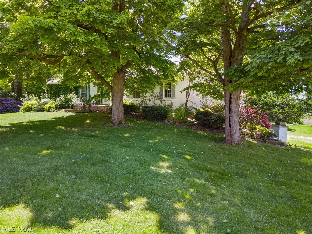 This picturesque property boasts a sturdy three-layer brick construction, nestled on 3.09 acres of land on a corner lot. You'll enjoy breathtaking sunsets from the deck, overlooking a scenic backyard with room to roam. Nature provides a backdrop for outdoor gatherings with friends and family. The roof, replaced in 2013, offers peace of mind with its single-layer installation. Inside, over 2300 square feet of living space awaits, featuring a newer bay window in the dinette area, flooding the space with natural light and offering views of the wooded surroundings. The home offers ample storage with two kitchen pantries, two lazy susans and storage nooks galore perfect for organization enthusiasts. With a heated garage and country living ambiance, it provides comfort and convenience. The well pump, replaced around 2017, ensures reliable water supply. Additionally, the property features 2.5 baths and a swing set in the backyard, adding to the charm. Though boasting century-old charm, with a touch of imagination, this home could be restored to its former glory. It's location offers the tranquility of rural living while remaining conveniently close to city amenities, making it an ideal retreat for those seeking the best of both worlds.