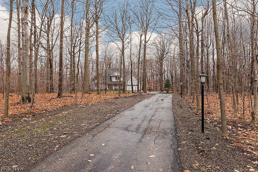 Sophisticated colonial on 5 wooded, peaceful acres with many luxury updates and conveniences. Two story vaulted great room with gas log fireplace opens to outstanding kitchen with granite countertop, under & above cabinet lighting and LG stainless steel appliances. Screened porch off kitchen that overlooks nature. Formal dining room.  Powder room. Over the top first floor master suite with gas log fireplace, wood floors, lots of windows, closet with custom shelving and tray ceiling with fan. Indulge in the master bath with heated floor, jetted tub, shower system and granite toped vanity with double sinks. Second floor includes two bedrooms, one with adjoining room; plus, finished room for office or hobby area–and, full bath.  Walk-in finished storage room on second floor. Fabulous walk-out lower level with finished recreation area and stunning full bath. Lower level potential for additional living suite with kitchen area with range and refrigerator.  Additional space for home gym, yoga