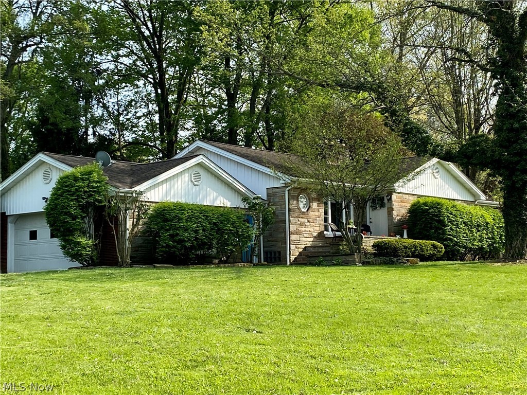 This lovely spacious stone and brick ranch sits on over 1/2 an acre in the sought after Poland Woods area! Your winding driveway leads to this lovely 3 bedroom 2 bath ranch home but also reflex's on the beauty of this neighborhood! Walk past your built in flower planter to enter your nice size living room with fireplace and tons of character with pocket doors, hardwood floors and a nice size Master Bedroom. To bring in the sunlight and show the beauty of this lot you have many large windows to enjoy this lovely development and see the walkers out for a stroll. The finished basement has a huge family room with a wood burning fireplace, full bath and laundry room designed as a bomb shelter in the 1950's. Enjoy your 3 season sunroom that leads to your fenced in backyard! The oversize two car garage has nature stone and built ins. Come see this lovely home before it's sold!