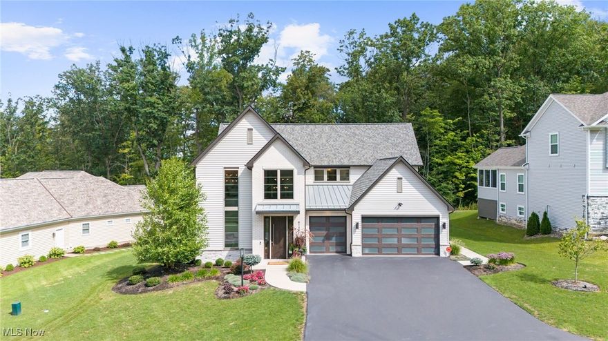 Stunning Modern-Contemporary Estate in Canyon Ridge. This exquisite home offers immediate availability and masterfully blends modern design with thoughtful Living in Place features. With nearly 3,900 square feet of luxurious living space, plus a 500 SF covered porch and a full daylight basement, this home is designed to impress at every turn. The open first floor showcases a magnificent great room with soaring 14' ceilings, a striking linear fireplace framed in limestone and tile, and an elegant dining space with a custom feature wall. The chef's kitchen is a dream, complete with an oversized 8' island, professional-grade appliances, granite range hood, and a walk-in pantry with dual refrigerator/freezer connections. The first-floor primary suite is a true retreat, featuring a tray ceiling with indirect lighting, an expansive custom-organized closet, and a spa-like bath with contemporary vanities, private water closet, and a zero-entry custom shower. Upstairs, two additional suites each include walk-in closets and beautifully finished en-suite baths. Outdoor living is redefined with the covered rear porch, featuring a linear vent-free fireplace, two Bromic radiant heaters, BBQ connections, rough-ins for automated screens, and a tongue-and-groove wood ceiling perfect for year-round enjoyment. Located in the prestigious Canyon Ridge subdivision, homeowners enjoy true maintenance-free living with lawn care, snow removal, and refuse services included. A rare opportunity to own a showcase property that embodies elegance, comfort, and innovation. This home is a must-see.