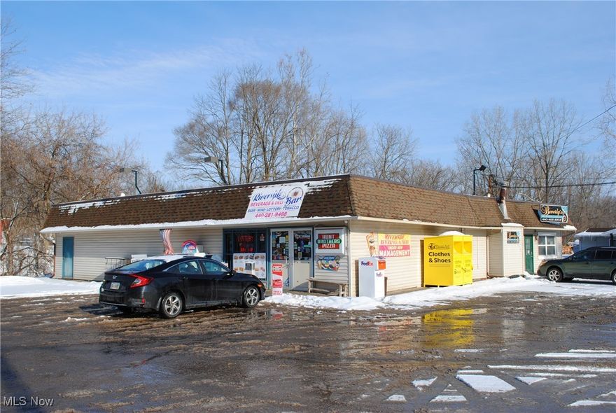 Attention investors! This unique property offers a prime investment opportunity in Elyria.  Great location with easy access to highway.  Property consists of beverage store / deli, beauty salon, single family home and large garage / outbuilding.  2 parcels on 1.67 acres next to the scenic "Black River."  Call agent for more information.