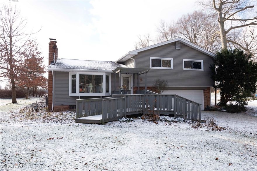 Don't miss out on this affordable split level home in Copley/Fairlawn schools!  Inside, you're greeted by a large living room with wood burning fireplace and large bay window.  Enjoy preparing delicious meals in your eat-in kitchen with stainless steel appliances, plenty of cabinetry, and mini wet bar.  Upstairs you'll find 3 generously sized bedrooms with hardwood flooring and a full bath with tiled shower surround.  The lower level features a half bath, coat closet, and access to the garage.  In the basement you'll find built in storage shelving, a wood workbench, wine cellar, utility room with washer/dryer (stays) and a high efficiency furnace (2022).  During the warmer months, entertain friends and family on the large deck as you gaze out across the back yard and farmland beyond.  Grow your own vegetables in the fenced-in garden.  Air conditioning also new in 2022 and roof is under 10 years old.  Located minutes away from historic Copley circle with easy access to route 21.  Call your favorite Realtor and schedule your private showing today!