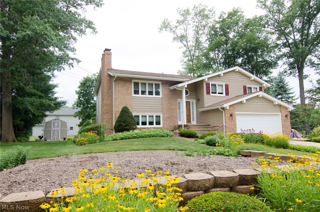 Picture perfect home in Ravenna Township. This home offers 3 bedrooms, 2 full bathrooms, a family room, bar, massive laundry room, patio, deck, 2 car attached garage with Miracle Stone flooring and another 2 car attached garage/workshop! The main level features a beautiful vaulted ceiling and large, open living and dining room areas. Spacious kitchen has stainless appliances, copper backsplash, sky light and tons of beautiful granite countertops and peninsula connecting to the dining room. Glass doors open from the dining room out to the composite deck and a wonderful view of the back yard. Extra wide hall closet acts as a pantry and coat closet. Large main floor bathroom has a double vanity with soft close drawers, separate shower and tub areas and opens to hall and master bedroom. Amazing family/entertaining space on the lower level. Large seating area with fireplace, dining/gaming area and gorgeous oak wet bar with slate flooring. French door open to the patio and yard. Yo