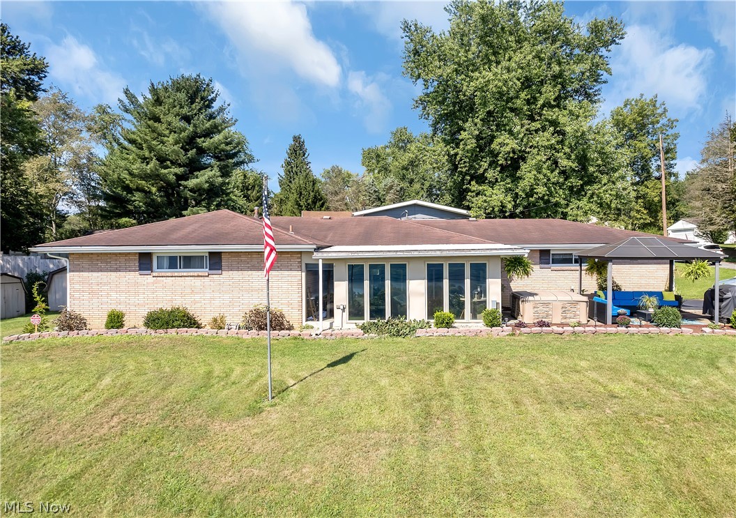 Welcome to this beautifully remodeled 3 bedroom, 2.5 bath brick ranch, located on the corner of Roslyn and Taylor street, overlooking the beautiful Ohio River and city of Wellsville. This homes features a complete (2022) brand new, never used kitchen. Including Thomasville cabinets, new counter tops, backsplash, smart core ultra premium waterproof vynly flooring, new lighting and brand new never used appliances. Additional great features of this home includes a wonderful four seasons sun room with a beautiful view, a master suite, a completely remodeled main floor bathroom (2022) with new flooring, wall tiles, bath tub, shower glass door, fresh new paint, and new solid-core doors. A newly finished and updated possible mother-in-law suite is located in the basement, including a living room, newly updated 2nd kitchen (2022), full bathroom and laundry room. Basement was previously handicap accessible. Updates of this home also include (2022) new landscaping, electrical and ring security system ran outside, (2021) waterproof flooring newly installed throughout first level, refinished wood floors in bedrooms, updated basement bathroom.Potential for washer and dryer to be moved to garage. You won't want to miss out on this home!