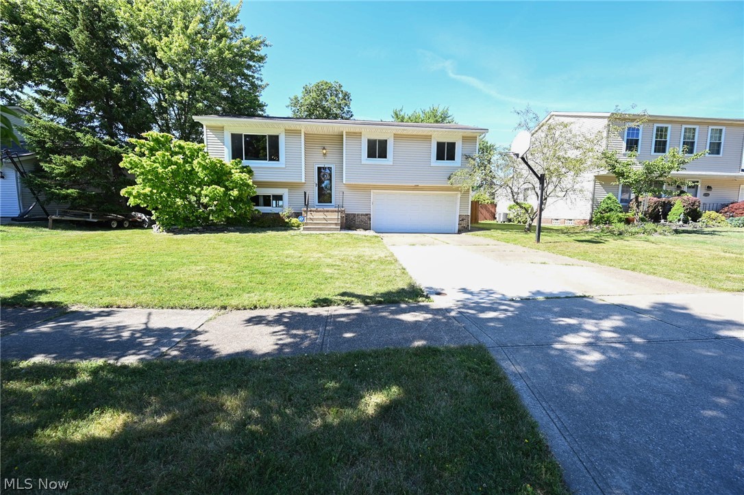 This cozy bi-level is a 3 bedroom, 2 full bath charmer with updates galore! It’s immaculate, warm & full of flexible space. You'll enjoy the open floor plan that features a 2 story foyer finished, lower level family room & new windows inviting all the natural sunlight in throughout. The oversized living room is the heart of the home leading to the open-airy dining room & kitchen. The kitchen has a beautiful patio slider that leads out on to the expansive 2 story deck & staircase to the massive lower level patio that's partially covered. This backyard is made for entertaining, coupled with privacy & open space for all of your backyard amenities, already fully fenced & generously shaded - just add your personal touches. This cozy bi-level is complete with a laundry/mud room, large closets, loads of storage & an attached 2.5 car garage that allows room for all the extra toys and your very own workshop. Don't wait, Call today for your private tour!