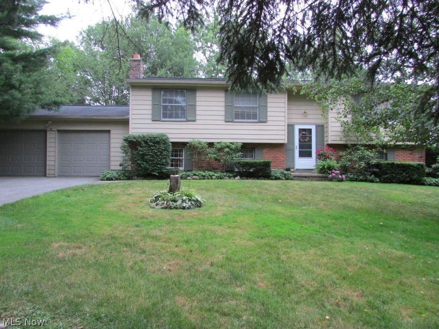 Fantastic bi-level home in a great location! This home has been well maintained and has so much to offer! Great layout with 4 bedrooms and 2 1/2 bathrooms! The upper level is the main level with living room, large dining area, and kitchen. The main floor master bedroom has a private bath and plenty of closet space! A huge back porch off of the dining room overlooks the scenic backyard and has a stairway down to a second outdoor entertaining area and covered patio. The lower level includes 2 bedrooms, a rec room with fireplace and a half bathroom. There's a 2 car garage and an abundance of storage space in this spectacular home! It's a must-see! Additionally, the home has passed the Geauga County septic inspection so you can buy with confidence!