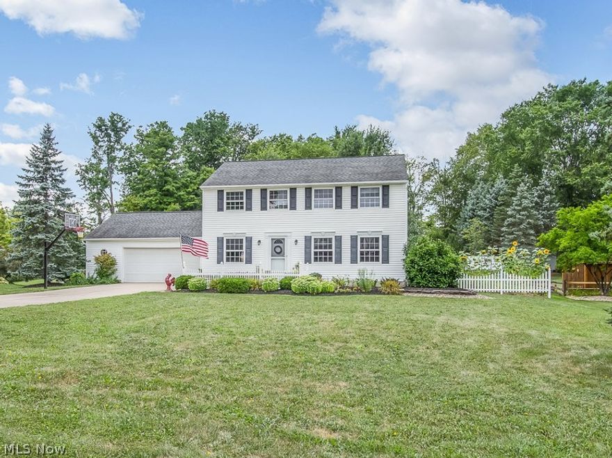 This impeccably clean, updated & tastefully decorated home boasts an open floor plan w/natural maple flooring, kitchen w/ granite counters, stainless appliances and KraftMaid beadboard cabinetry w/pullout drawers, glass corner cabinets & under-cabinet lighting.  The oversized great room features a large eating area, vaulted ceiling, crown molding, recessed lighting & gas fireplace surrounded by arched windows, highlighting a stunning western view of the private wooded backyard. Sliding glass doors lead to covered 500 sq-ft brick paver patio w/remote-controlled ceiling fans, 4-post lantern-lighting, hook-up for natural gas grill, all overlooking the 1 acre landscaped yard complete with greenhouse & 10x16 storage shed.  The upper level master suite features updated private bath w/quarter-sawn cabinetry, marble counters & walk-in closet. 3 additional bedrooms & full bath w/quarter-sawn cabinetry & marble counters complete the upper level.  Finished lower level offers large family/rec room