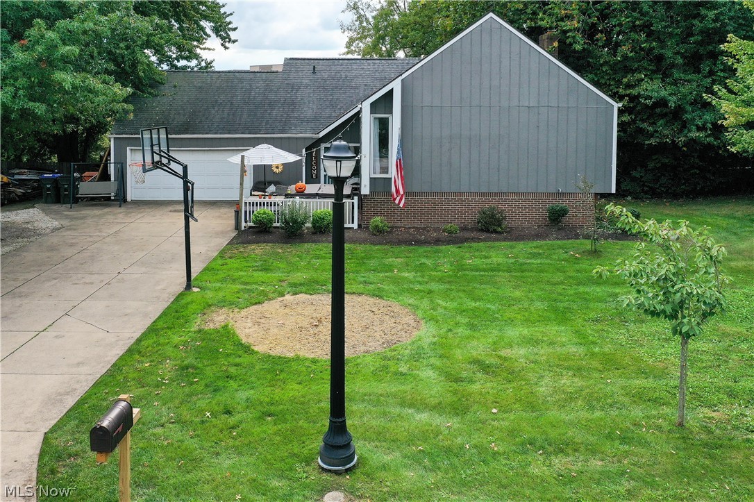 412 Wyoga Lake Blvd, Stow, Ohio 44224 is situated in the highly desirable neighborhood of Wyoga Lake Estates of Stow however in the acclaimed Woodridge School District and having Cuyahoga Falls utilities. This home has a lot to offer including over 2,600 square feet of living space between the upper level and lower level with full storage area above the 2 car garage. Private back yard is enclosed by a fence and makes this the perfect place for play areas or letting your dogs run free. The upper level of this split level home has many updates including removing the wall between the Kitchen & Living Room to create the open floor plan that everyone loves; new flooring throughout the living room, kitchen and hallway; tile and painted bathroom as well as other recent items such as Roof approximately 2014, electric panel, furnace 2015, great central air conditioning, painted throughout and others. Relax with the ambiance of two gas fireplaces, one on each level and great views of the back ya