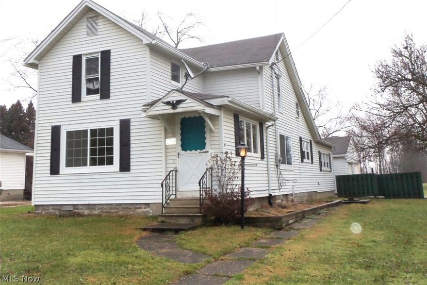 Century Colonial with neutral paint and laminate flooring thru out. Formal dining room and family/media room offer cute built-ins for displaying your treasures. Large living room offers built-in bookshelves and desk area. 2 roomy upstairs bedrooms with cedar closets, walk in storage area and full bath. Huge mudroom/laundry room and partial basement.  Covered patio between home and detached 2 car garage.  Nice 3/4 acre lot in Farmington Village.  Sewers are on their way! Ready and waiting for its new family.  Family/Media room could be used as 1st floor bedroom.