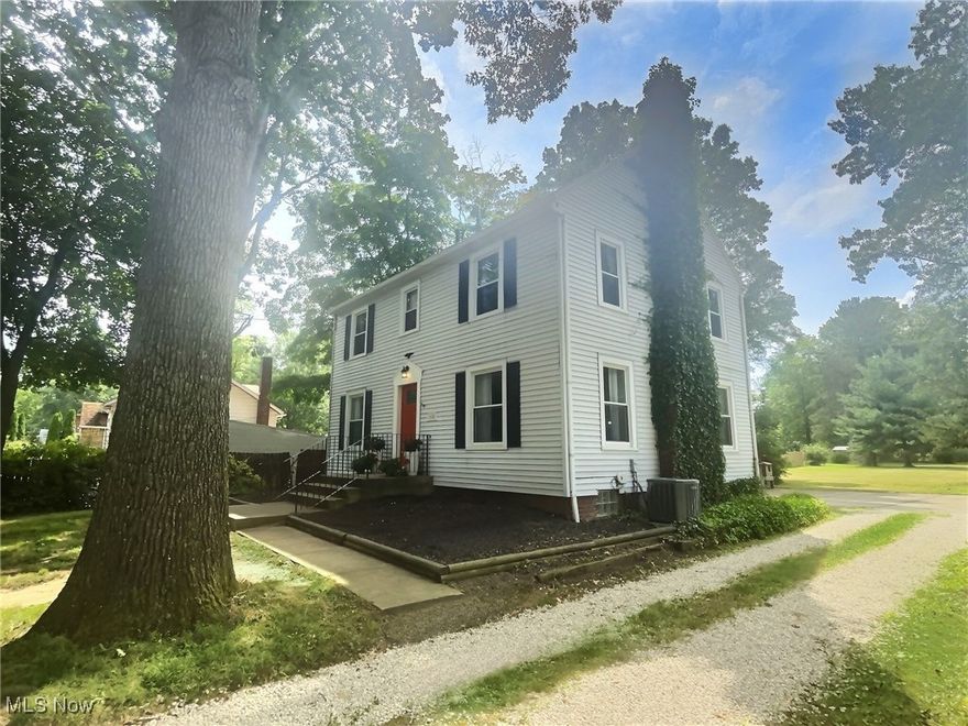 This exquisite, updated 4 bedroom picturesque colonial on .72 acres exudes charm and provides the foundation for endless potential. The property sits within Norton City School district and is conveniently located in close proximity to highway, shops, and restaurants.  Large living room featuring fireplace & formal dining room with built ins combine classic appeal with contemporary comforts including all new flooring and modern light fixtures. Modern, spacious kitchen provides new tile backsplash, updated appliances, and stylish cabinetry. Unique, Man-Cave style breezeway attaches to oversized (552 SF) 2 car garage at back of home. Half bath on main level has been remodeled with new vanity and flooring. Wide staircase leads to the second level to 4 large bedrooms with stunning restored hardwood floors that honor the home's heritage. Primary bathroom suite has been elegantly updated to include new vanity, custom tile shower/tub & tile flooring. Almost a full acre lot & semi-private yard provides expansive area to call your own and completes this beautiful estate's package. Very rare find in Norton! Schedule your showing today.