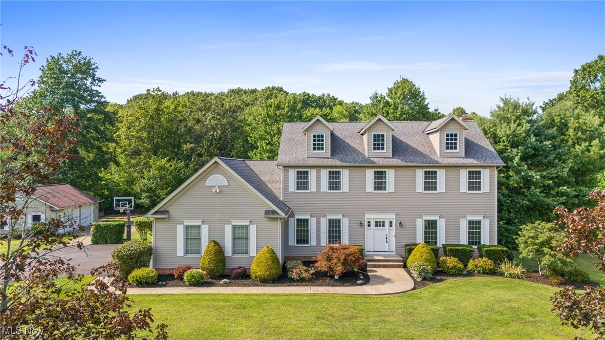 WELCOME HOME to this Beautifully Maintained Colonial set on 3+Manicured Acres in desirable Hampton Ridge! This warm and inviting home offers great living space with traditional floor plan, 4 Bedrooms, 2.5 Baths, high ceilings and tasteful neutral decor throughout. Foyer entry with hardwood floors open to both Formal Living Room & Dining Room. Bright and light Family Room with brick fireplace. Well-appointed Kitchen with abundance of cabinetry & counter space, center island breakfast bar, stainless steel appliances & ceramic floors through to Dining Area with transom slider to deck. Spacious Master Suite with vaulted ceilings, 2 walk-in closets plus 3rd closet & Glamour Bath with double sink vanity and soaking tub. Second floor also includes 3 additional large bedrooms with generous closet space & full guest bath with skylight. 1st floor Laundry Room & Mudroom with custom lockers/cabinetry. Finish the 13-course full basement and expand your living space with Rec/Playroom, Exercise area & storage room. New Gas Furnace & A/C installed 2024, HWT 2025. Freshly paved driveway, 2+car attached garage plus 32x24 detached garage/outbuilding. Enjoy peaceful wooded views from the deck overlooking nicely landscaped yard with manicured beds full of lush plantings & situated on deep quiet cul-de-sac lot. This home is ready for your growing family to make memories of their own! Close to shopping, restaurants, parks, golfing and just minutes to freeway access!