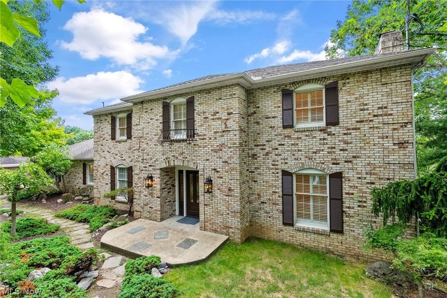 LOOK AT THIS BEAUTIFUL BRICK ESTATE...This gorgeous 6-bedroom property has been beautifully updated throughout and is soon to have a new roof. Careful consideration was taken to preserve the traditional design elements of this home that flow seamlessly through each space. A backdrop of mature trees surrounds the nearly one-acre lot and provides pleasing privacy that can be enjoyed from the tiered decking that cascades from the rear of the home and leads to fabulous entertainment space under a canopy of nature. A soaring entry, coffered ceilings, wainscoting, custom built-ins, gleaming hardwood, and exquisite moldings give a feeling of grandeur as you explore the more than 5500 sqft. The lower-level living quarters delights with an additional kitchen, multiple bedrooms, study, exercise room, full bath, and walk-out access. A unique pattern of pavers forms the driveway and is flanked by double garages providing 4 stalls, a convertible lift, and 2 additional parking spaces for guests. New for You updates from the inside out make this prestigious property move-in ready and a must-see.