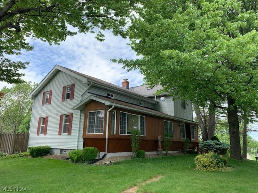 A unique blend of historic character defines the original structure (1850) merged artistically with a dramatic cathedral ceilinged great room constructed in 1993 with an amazing four car garage below.  Sky lights and specific lighting directed toward various nooks and lofted areas create focal points.  The random appearance of these bridges above have been skillfully designed to enhance and display artwork, pottery, antiques or holiday décor in full view, yet protected from admirers. Amid the second floor rooms, retaining historic ambiance, you are enchanted upon entering the amazing master bedroom suite, vaulted ceiling, spacious closets, and an inviting jetted tub, the view of which is partially obscured by glass blocks rising aesthetically as a diversion.  Situated on a .61 acre corner lot, the home appears majestic as the tiered deck and gazebo provide privacy sheltered by towering trees, as well as colorful decorative trees and vegetation.