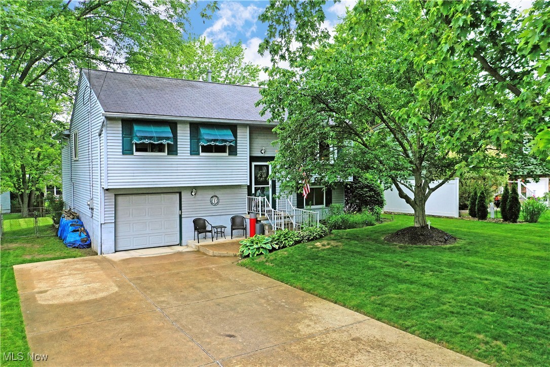 This beautifully maintained 4-bedroom bi-level home in the Girard City School District is ready for its new owner! Offering both comfort and functionality , this spacious residence is ideal for those looking for move-in ready convenience and stylish features. The large kitchen features white cabinetry, dark countertop's, a large pantry, and a full suite of stainless steel appliances- including refrigerator,stove,dishwasher, microwave with moveable wood cart/island. A charming built-in coffee bar completes the space. Enjoy plush, well kept carpet and generous nautural light throughout. The hallway bath features a tub/shower combo and linen closet. Further down the hall are four generously sized bedrooms each with ample closet space . Updated windows throughout the home with a transferable warranty. The lower level will have you cozied up to the stunning wood burning fireplace in the carpeted family room. It features a convenient walk-out access sliding glass door to the concrete covered patio to enjoy the the wood patio swing with a fenced in yard for your privacy. Spacious laundry room features a washer and dryer that stays. Attached 2 car deep garage has plenty of room for your toys, and an updated electric box. All located in a desirable, established neighborhood with easy access to schools, shopping, and local amenities.