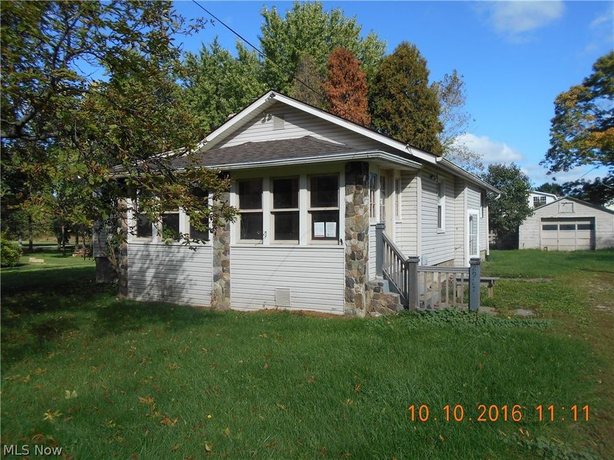 Three bedroom home with large eat in kitchen. First floor laundry area off kitchen. Enclosed porch on the front. Fireplace in living room. Large corner lot with garage. Solid home that just needs a little work to make it shine.