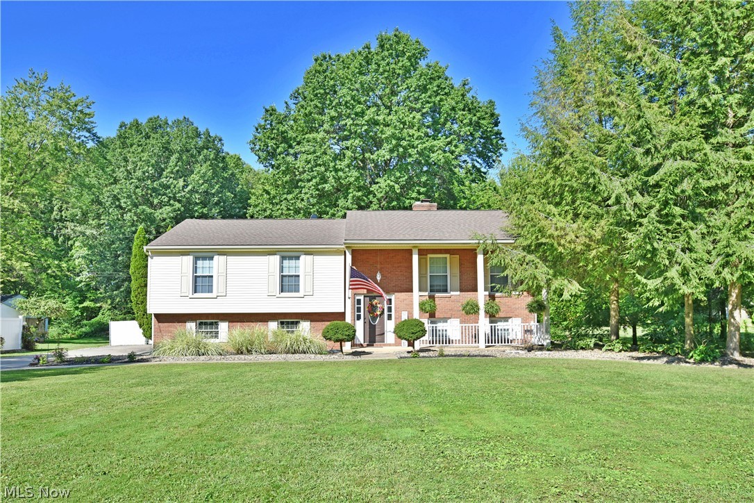 An absolute stunner, packed with tasteful, high-quality updates in its expansive two-story split-level layout; all topped with a multi-tiered rear patio and a private, inground pool with gazebo! This brick faced Howland treasure isn’t one you’ll want to sleep on, and it’ll only take a quick look to see why. Sat far off the street, a quartet of tall pillars mark the front entryway while a two-car garage wraps alongside, leading to the fenced in oasis out back. Step inside to a prominent foyer, as dark stained woodwork beckons you up to the main floor. Rich, hardwood style flooring fills the nearby family room as natural light dances across, peering past the French door hidden dining area. An elaborate kitchen awaits nearby with an elegant, horseshoe layout is complete with stone countertops. Stainless appliances shimmer between white cabinetry while the dining room opens to the expansive rear living room, showcasing poolside views from the window lined wall. The main hall is home to a f