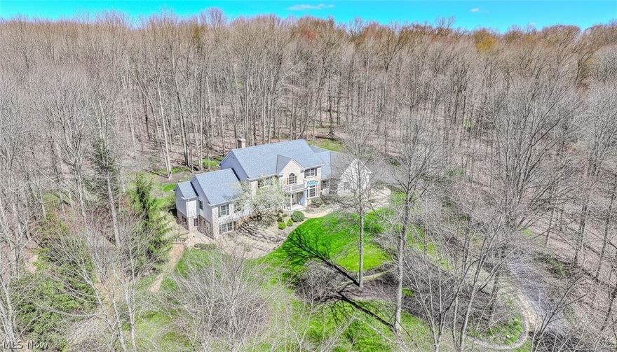 Exclusive hilltop property in the The Sanctuary is set back on over 2 acres, offering privacy and one of a kind outdoor beauty and indoor comfort. Offering 5,600+ sqft of finished living space, this stately colonial features 5+ bedrooms, 4 full baths & 2 half baths, designed for both everyday comfort & upscale entertaining. A dramatic two-story foyer welcomes you, flanked by a formal dining room & formal living room. The heart of the home is the impressive two-story great room with custom built-ins, a gas fireplace, and a wall of windows showcasing peaceful wooded views. The chef’s kitchen is open and inviting, featuring high-end appliances, a large island, wet bar, and French doors that lead to the paver patio—perfect for indoor/outdoor entertaining. 1st floor owner’s retreat w/ a tray ceiling, spa-like ensuite including double sinks, makeup area, soaking tub, stone tiled shower & an extra-large walk-in closet w/ custom built-ins. The main level is completed by a beautiful off the library with built-in bookshelves, two half baths, & convenient and functional laundry room.
Upstairs, you’ll find 4 generously sized bedrooms, w/ two spacious Jack-&-Jill bathrooms. The newly updated lower level expands your living options w/ new LVT flooring, a sitting area w/ gas fireplace, sliders to the backyard, & a large wet bar. This level also includes a full bath, gym w/ built-in cabinetry, a flexible bonus room featuring a 4–5 person Canadian Hemlock sauna or easily converted into an additional bedroom. Lets not forget the utility space with ample storage with tons of shelving.  Outside, enjoy a serene backyard oasis w/ a paver patios and water feature. The extra-large heated three-car garage adds even more convenience.
 There are so many updates & upgrades - Please reference the upgrades list in the supplements. Ideally located close to freeways, shopping & restaurants, this exceptional property offers luxury, privacy, & functionality in one remarkable home!