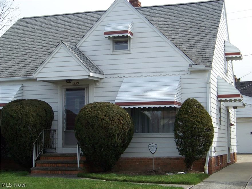 By far the best buy in Maple Heights.  This home offers a lot in one neat and clean package! Inside you will find two good size bedrms on the first floor which are currently carpeted (wood underneath) and a full bath. One bedroom has a door which exits to the yard. There is a huge finished dormer up with one 12 ft closet plus a normal size carpet. There also is a nook area measuring 10 x 6.  The lower level is fantastic!!  You will find a Rec Rm with gorgeous wood paneling along with a corner wet bar and special lighting around the entire room.  Also on the lower level is a roomy laundry area as well as a place to set up a workshop.  "FOR THE GUYS" - check out the garage!  It is a 2 1/2 (a bit more!) HEATED garage with lots of floor space. There is a special steel beam across the full width of the garage for hoisting engines plus a drain.  There also is extended aluminum lighting around the entire ceiling.  The yard is very well kept with plain, neat landscaping.  The roof on the house