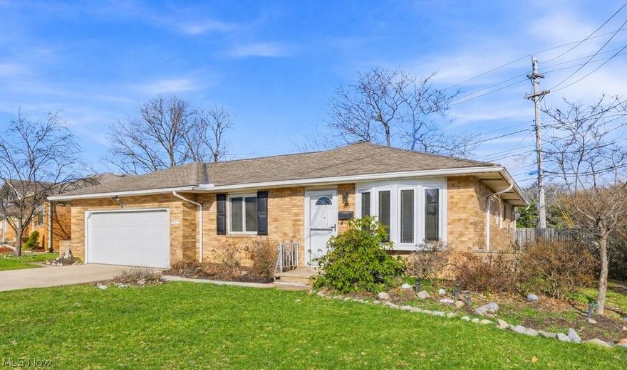 MOVE-IN READY! This charming 3-bedroom, 1.5-bath ALL-BRICK ranch in Garfield Heights offers convenient one-floor living with an oversized ATTACHED two-car garage, tucked away on a dead-end street. Beautiful hardwood floors run throughout the main living areas and bedrooms. A large picturesque bay window fills the living room with natural light. This well-maintained home features thoughtful updates including neutral paint throughout, modern lighting, updated door hardware, and central air conditioning.
The kitchen offers abundant cabinet space, a modern backsplash, is equipped with appliances, and flows seamlessly into the living and dining areas. All three bedrooms are located on the main level, each offering generous closet space along with additional hallway storage. The primary bedroom has direct access to a convenient half bath, while the full hallway bath features an updated shower/tub combination. The full partially finished basement provides additional space ideal for laundry, storage, recreation, a home gym, or office. Additional updates include newer windows and exterior doors. Step outside to enjoy a private partially fenced backyard shaded by mature trees, perfect for relaxing or entertaining on the patio. Conveniently located near major highways, schools, shopping, and parks. Take pride in calling this home your own!