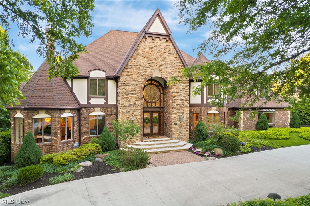 Prestigious custom-built, 6 bedroom Estate w/ over 12,000 sq ft of living space! The exterior boasts lush landscaped grounds, front & side entry driveway, 3 car side load garage & gorgeous curb appeal! Impressive 2 story foyer, stunning split staircase & beautiful lead glass front door! Custom quality features throughout the open floorplan that includes custom molding, 6 panel solid wood doors, Andersen & Pella widows & doors & 2x8" construction. Amazing 2 story family room w/ floor to ceiling window wall, beamed ceiling & fireplace. Easy entertaining throughout, starting in the 22x20 bar area, elegant formal dining room, lovely living room & expansive eat-in kitchen complete w/ limestone floors, travertine backsplash, custom cabinetry, Corian counters & included appliances. Private office w/ cathedral ceiling & built-ins. Convenient bedroom, full bath & laundry on the main level. The gracious open stairway takes you to 5 bedrooms all w/ WICs, showcasing the luxurious owner's suite w/ sitting room, FP, balcony & glamour bath w/ heated floors, custom shower, & WICs w/ custom built-ins. Awesome 3rd-floor bonus room w/ cathedral ceiling, storage, & 1/2 bath. State-of-the-art finished walkout basement w/ large rec room w/ custom stone FP, game room, wet bar, gym, spa, Hot Tub, steam & dry sauna, lockers & 2 full baths. Enjoy the private, resort-style backyard w/ a 40x20 salt water heated inground pool, Hot Tub, pond area w/ waterfall features, fire pit, decks & patios.