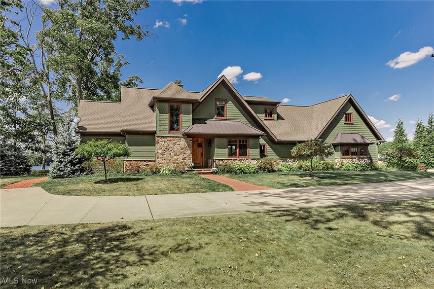 Nestled within the prestigious Congress Lake Club (CLC) community, this rare 1.15-acre property offers an extraordinary opportunity for luxury lakeside living. Located in Hartville (Lake Township), the home was custom-built in 2018 and designed by Peninsula Architects.  The result combines modern design with timeless and elegant craftsmanship.  This residence showcases high-quality finishes, focused on function, natural light and ample storage throughout. The open floor plan on the main level features beamed ceilings a great room with a statement stone hearth and fireplace.  The generous space provides a dining area and gourmet kitchen made complete with a live edge table for additional counter space.   The oversized windows + doors provide natural light at every turn.  There is a custom and functional bar with an undercounter refrigerator, pantry area and laundry + mudroom on the main level. The first floor also features a bedroom with vaulted ceilings that is en suite to a full bathroom. A convenient elevator connects the main and second floors, while the attached garage with attic storage adds functionality. The owners suite, complete with a private balcony is an oasis.  Custom craftsmanship, meticulous attention to detail, and ample storage create an environment ready for everyday enjoyment + effortless entertaining.  The seamless blend of interior and exterior living spaces is rarely found and makes this home truly special. From sunrise to sunset, enjoy breathtaking Congress Lake views, occasionally accompanied by the iconic Goodyear Blimp fleet.  Set within a private, gated section of the Congress Lake Club (CLC) this property offers both security and exclusivity. Membership to Congress Lake Club is required, granting access to its storied traditions and resort-style amenities including golf, tennis, swimming, and lakefront recreation—perfectly complementing this one-of-a-kind lifestyle.