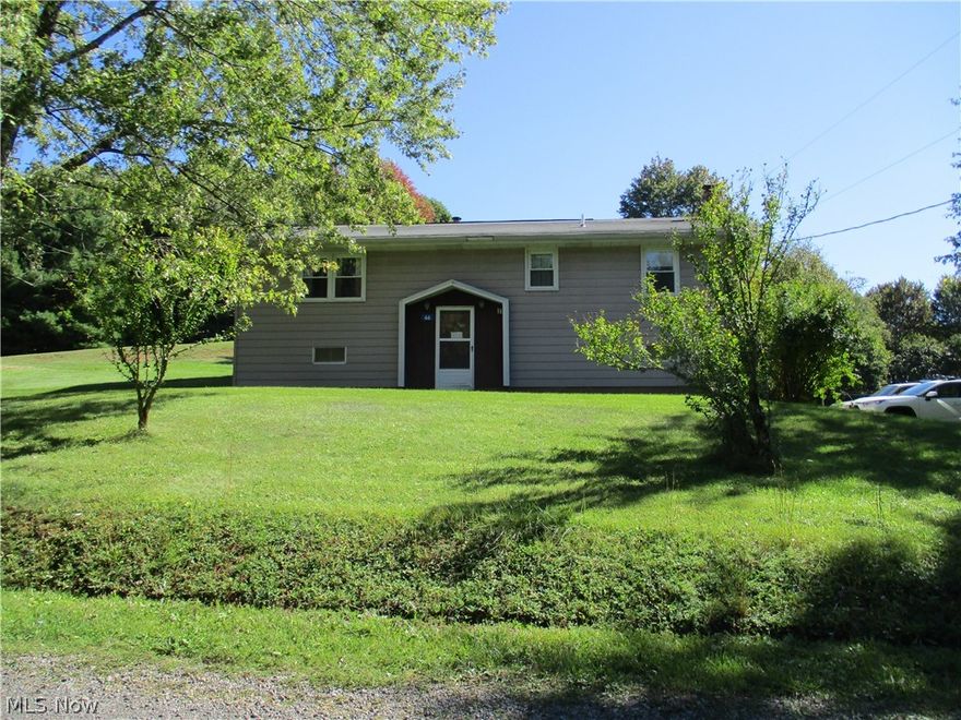 Sit back & Relax on the newly constructed deck overlooking the serene 2.72 acre lot featuring apple, peach, pear, chestnut & hickory trees along w/blueberr bushes.  The split entry home features replacement windows, beautiful laminate flooring in LR, hall & foyer steps, updated bath & sunroom addition on rear of home. Integral single car garage + 2 car detached w/opener. Home Warranty Included.
