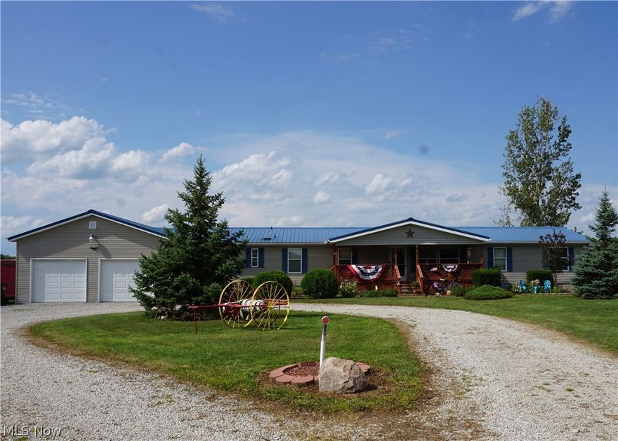 Truly a must see!  Ranch home on nearly 11 acres!  This home features an open floor plan complete with a spacious master bedroom and private master bath.  The other side of the home boasts three additional bedrooms and a full bath.  The inviting front porch takes you into a cozy living room that opens into the dining room, kitchen, and family room with fireplace.  All new stainless appliances stay to compliment the custom kitchen.  The enormous basement - featuring painted walls & floors - is perfect for extra living space, hobbies and storage.  There are two sump pumps. The attached 6 car garage is a car-lovers paradise.  It is a true extension of the home.  Once outside you will be welcomed with an expansive view filled with grapevines, peach, cherry, apple and plum trees, blueberry bushes and a garden.  The property also features acres of trails for four-wheeling or can be mowed for more yard.  Perfect for camping!  The property also offers several outdoor buildings. One is 24x32 wi