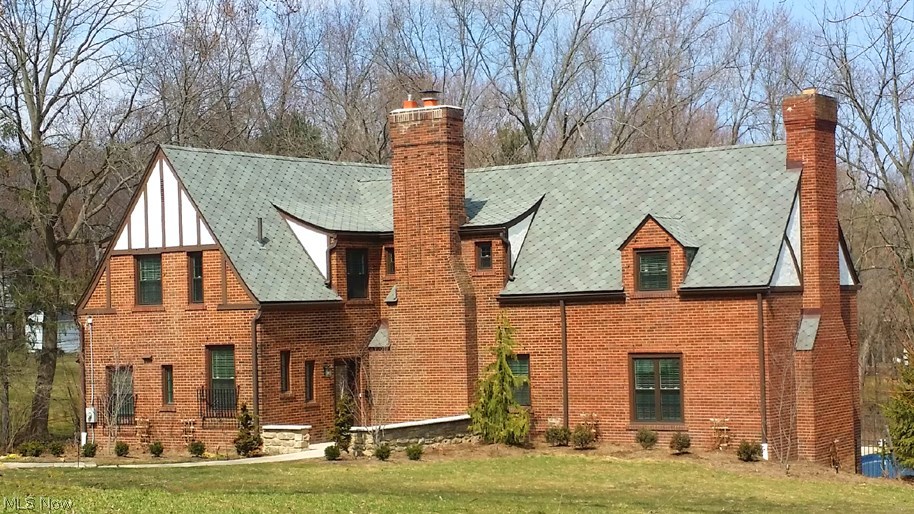 This beautifully updated Tudor sits majestically on over an acre of land. The open floor plan Kitchen includes granite counter tops & Island, stainless steel appliances & wainscoted cabinetry. The formal dining room/sun room feels bright and airy with its many windows and serene views. A stunning white marble fireplace is a focal point of the Great Room, along with bay windows that overlook the spectacular in-ground pool & fountain. The library/theater room has gorgeous woodwork, built-ins, fireplace & granite wet bar w/refrigerated draft beer system. The 1st fl laundry/mud room & half bath complete the first level. On the second level, the Master Suite features double sinks, frame less glass door tiled shower, spa tub, private water closet & two walk-in closets. Three spacious secondary bedrooms have abundant closet space as well. Great care has been taken during renovations to retain many of the original design elements of this amazing home! See brochure for detailed updates!