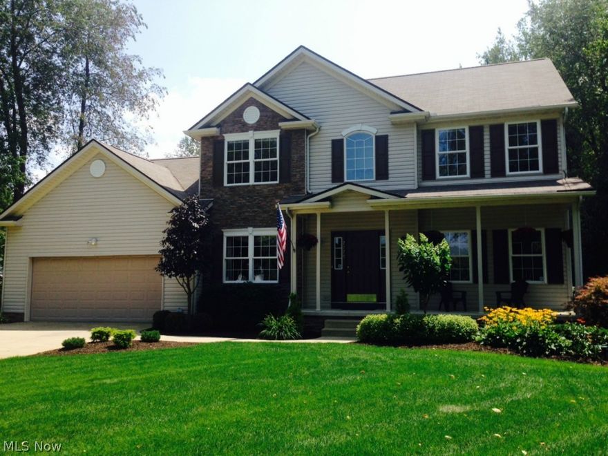 This spectacular 2440 sq.ft. home is only 13 years young and is situated on a private 1.5 acres. Located just minutes from Cle-Mass Rd or Interstate 77, this well cared for, 1 owner, no kids home has 4 bedrooms and 2 1/2 baths and also features a full basement, just waiting for your finishing touch. From the moment you walk in, you will appreciate the very open floor plan, hardwood floors and the distinctive oak stair case. This is not your typical colonial.  The open and airy kitchen with an island feature includes ALL appliances. The family room features a fire place and is located adjacent to the large eat in kitchen, perfect for family time and entertaining. No carrying laundry into the basement as there is a 1st floor laundry room off the kitchen, an immaculate two car garage that is extra deep and a first floor half bath. The master bedroom with a vaulted ceiling is full of light and has a full walk in closet and master bath with an oversized tub and a separate shower. The other