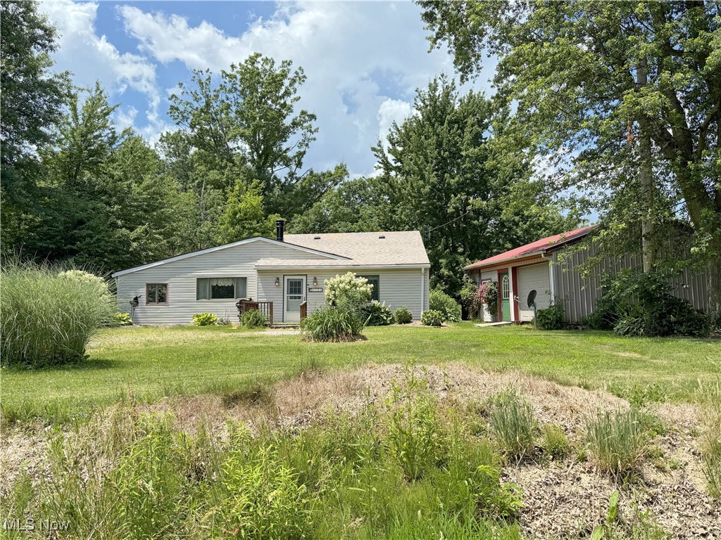 Opportunity knocks! Ranch home nestled on 3.6 beautiful wooded acres in Western Reserve Schools. This property offers privacy, potential, and plenty of space to make it your own. The home features a cozy living room with a wood-burning fireplace, an eat-in kitchen, three bedrooms (note: not all have closets), a bathroom with a ceramic step-in shower, 1st floor laundry (washer stays), and a large addition that expands the living space with a family room, full of possibilities, and leads to a wooden deck overlooking the lush backyard. For those who love to tinker, create, or need extra storage, there’s a 24x24 workshop with a garage door—perfect for hobbies or equipment. Yes, the home needs work—but with some vision and effort, this could be the perfect country retreat or investment opportunity! A 2nd layer of shingles was added around 2023. Any mineral rights will transfer to the buyer. Call to see if this is the one for you! Cameras on property.